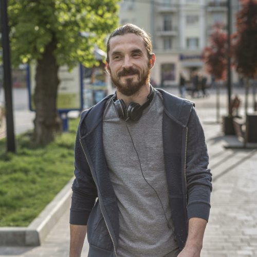 front-view-man-with-headphones-city