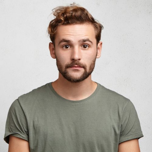 horizontal-portrait-attractive-caucasian-man-with-beard-mustache-looks-seriously (1)-min